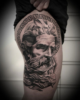 Vlogigurl tattoo of Zeus on a leg. Black and gray realism.