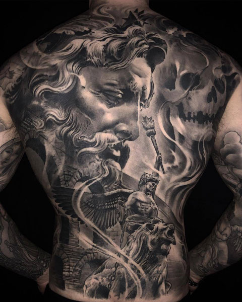 Full Back tattoo of Zeus, a skull, a lion with winged women ridding it, and a stone bridge. 