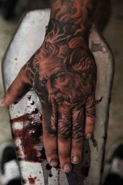 Stylish and realistic tattoo of Zeus on a hand.