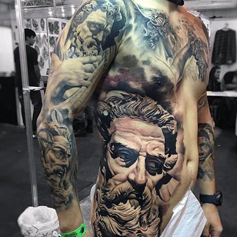 Half body tattoo of Zeus's face.