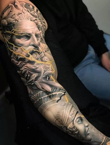 Full sleeve Zeus tattoo with female warrior underneath him. Yellow lightning going throughout the tattoo.