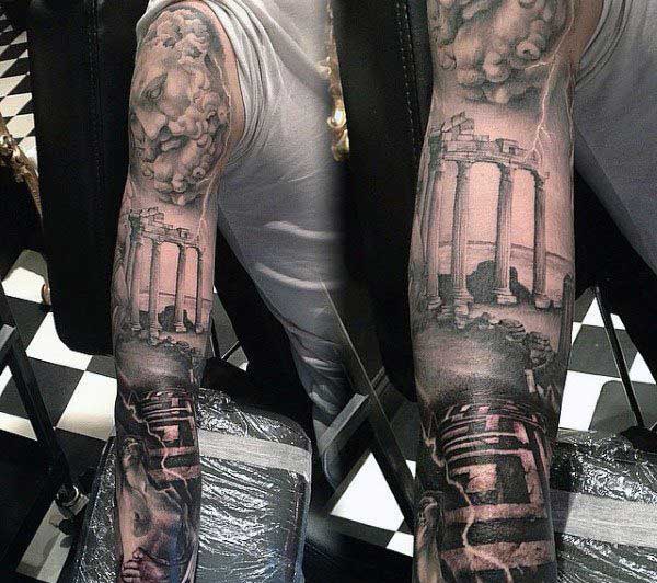 Zeus full sleeve tattoo with Zeus at the top, a roman building in the middle, and a maze and women at the bottom. Zeus's lightning is also scattered throughout the tattoo. 