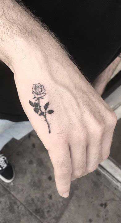 rose ink on man hand